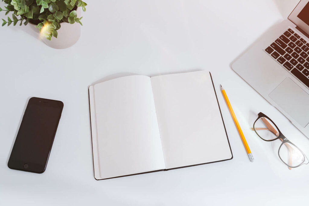 book and laptop on table