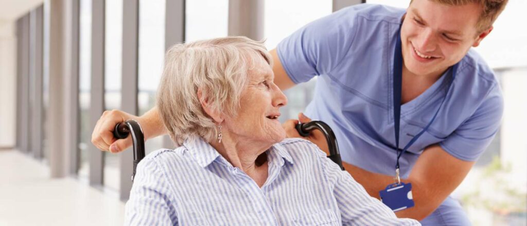 healthcare assistant smiling with elderly lady