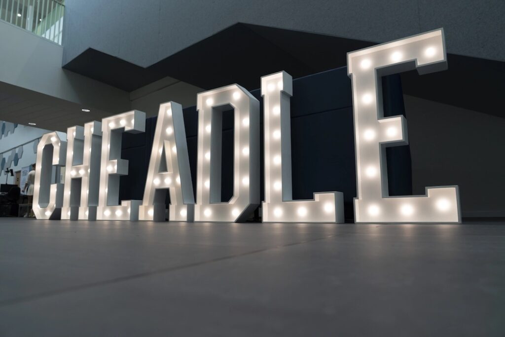 Illuminated sign saying 'Cheadle' on display at the new Cheadle campus