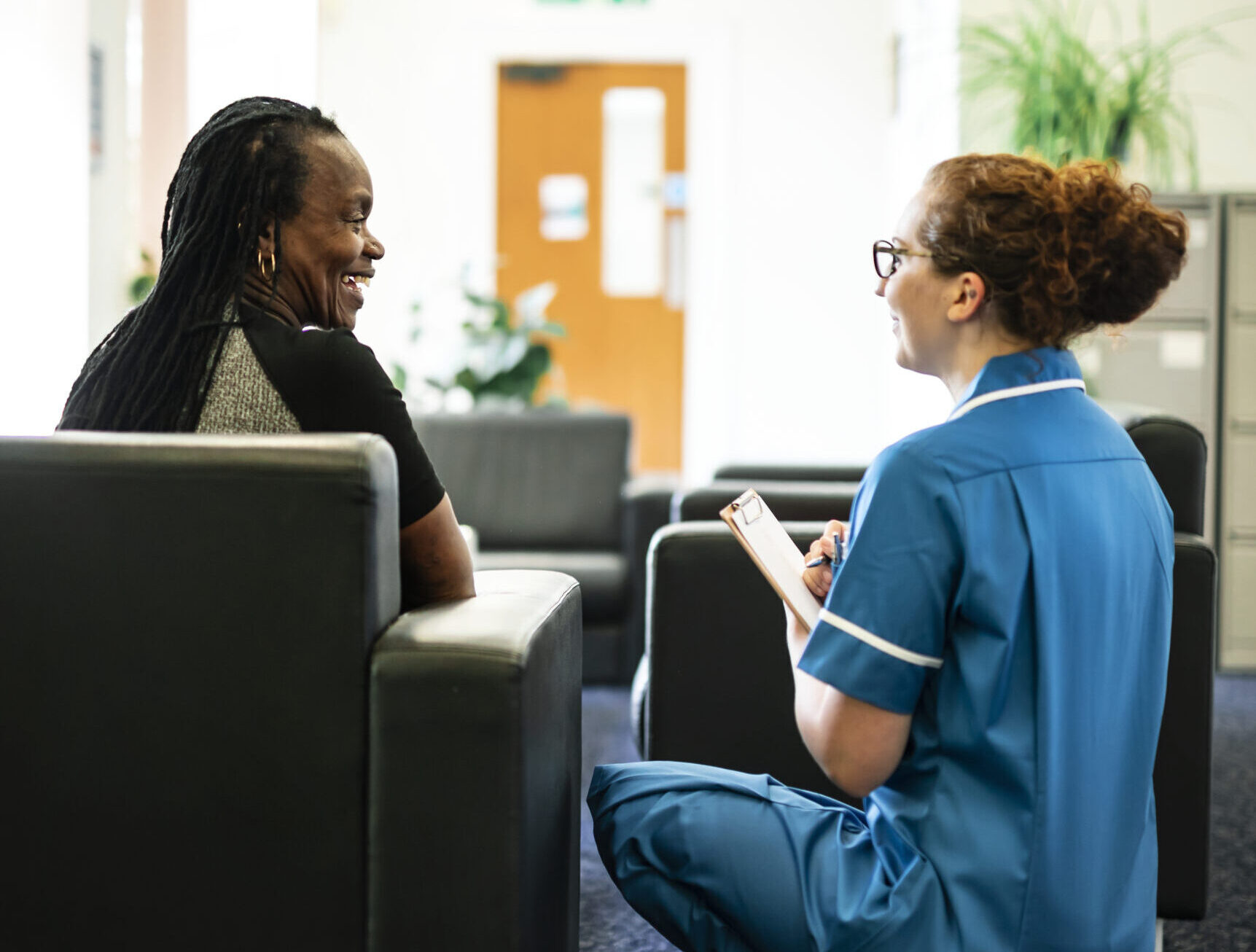 Nurse speaking to a patient in the waiting room